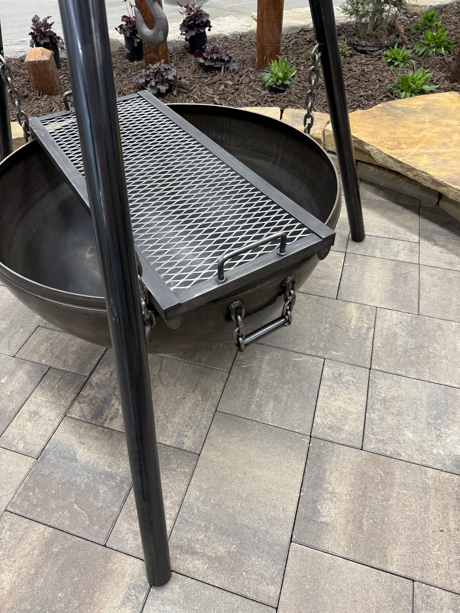 Side View of Grill Grate Laying across Fire Bowl on Hanging Tripod Fire Pit Model - Rough & Rigid